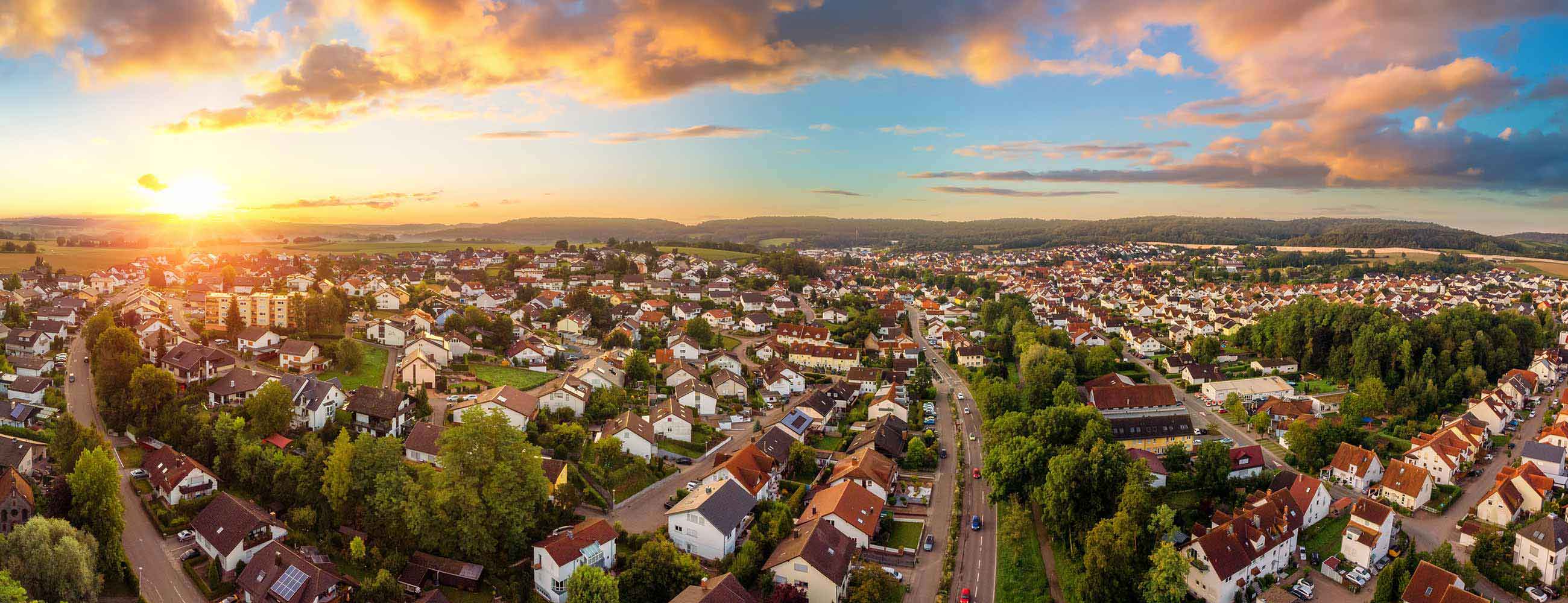 Sun rising over a suburban neighborhood.