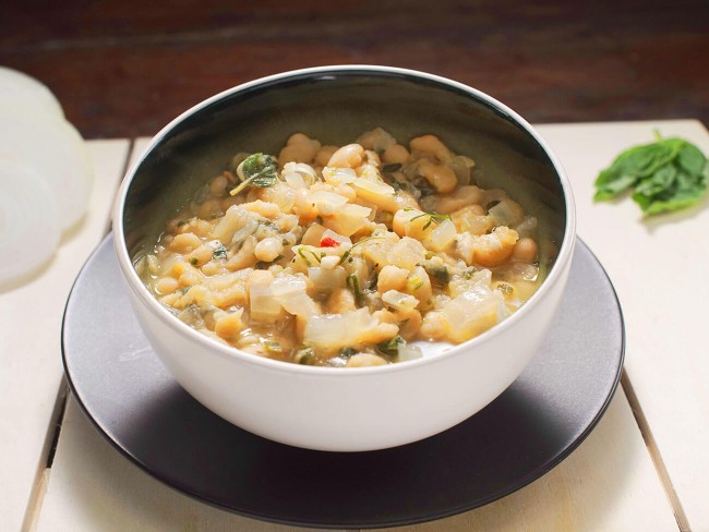 bowl of white bean soup with onions and sage