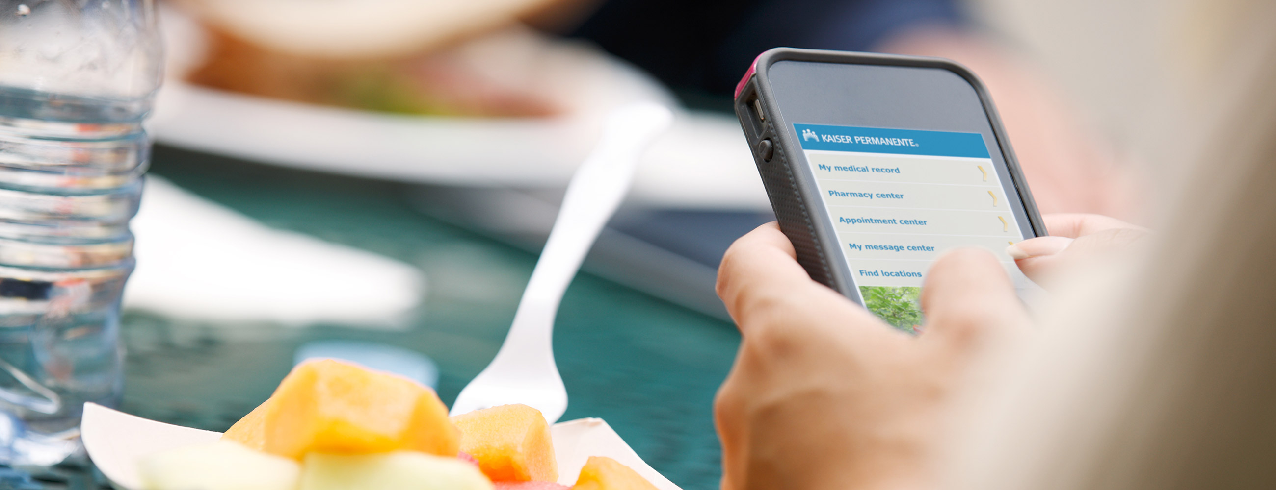 A closeup of a pair of hands holding a mobile phone.