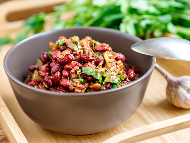 Pinto beans and greens in gray bowl